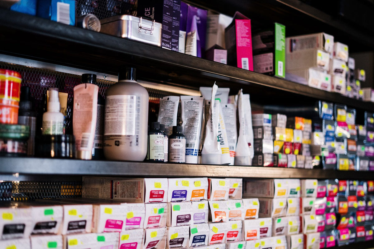 Professional hair products neatly organized on salon shelves